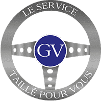 Logo GV sur emblème argenté : "Le Service Taillé Pour Vous". Symbole de qualité et d'expertise professionnelle sur mesure.